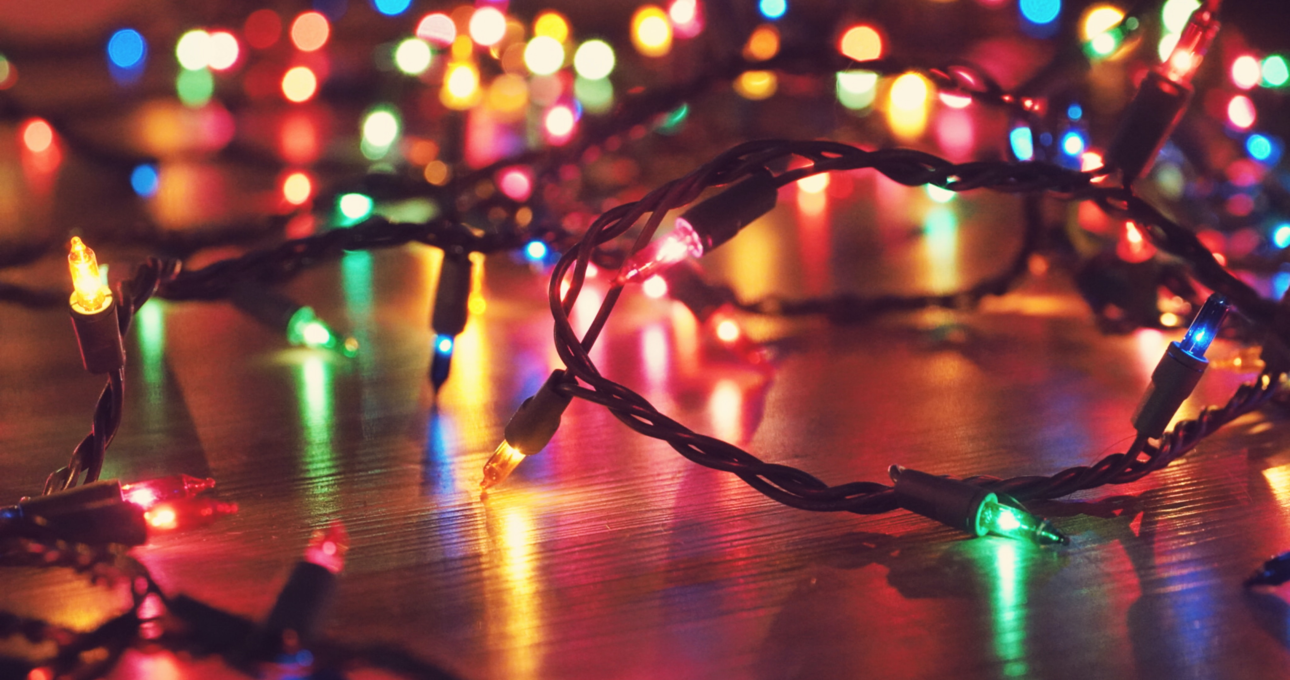 Powered on Christmas lights, laying on a floor.