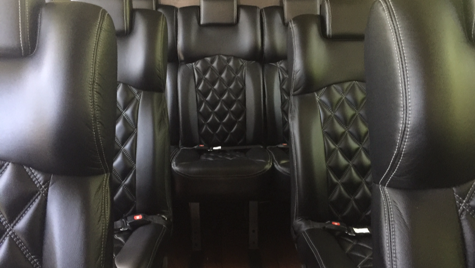 Inside our VIP Midsize motorcoach showing our leather seating.